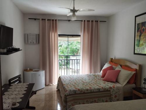 a bedroom with a bed and a window at Pousada Bem Querer in Penedo
