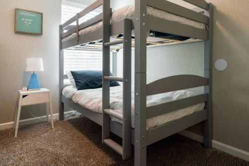 a bunk bed in a room with a bunk bed in a bedroom at Peaceful and Relaxing Getaway w Beautiful Pool in Richardson
