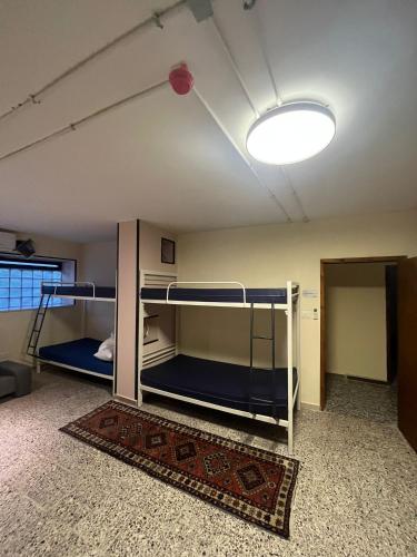 a room with two bunk beds and a light at Bethlehem City Hostel in Bethlehem