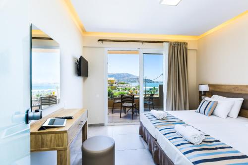 a hotel room with a bed and a balcony at Theo Star Beach Hotel in Malia