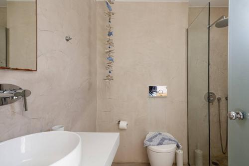 a bathroom with a shower and a sink and a toilet at Theo Star Beach Hotel in Malia