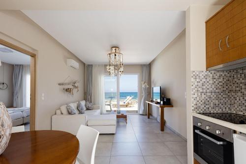 a kitchen and living room with a view of the ocean at Theo Star Beach Hotel in Malia