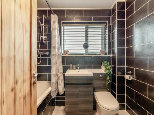ein Badezimmer mit einem WC, einem Waschbecken und einer Badewanne in der Unterkunft Druridge Hideout in Broomhill