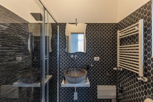 a bathroom with a sink and a glass shower at Casa dei Visionari in Bari