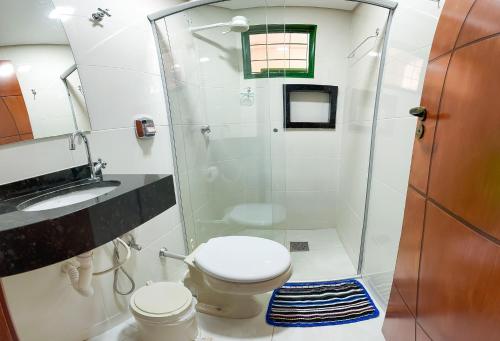 a bathroom with a shower with a toilet and a sink at Apto com Wi-Fi em Monte Castelo - Campo Grande MS in Campo Grande