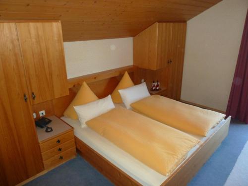 a small bedroom with a bed and a night stand at Ferienwohnung Panorama in Bad Kohlgrub