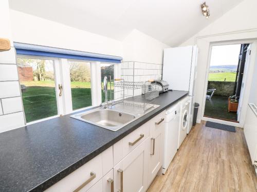 a kitchen with a sink and a large window at Freemantle Lodge in Ventnor