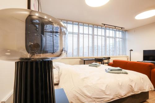 a room with a bed and a lamp in it at Studio 501 in Kaunas