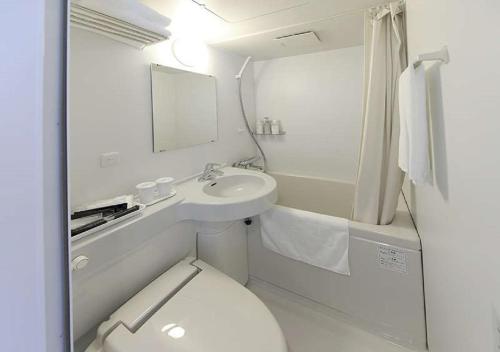 a bathroom with a toilet and a sink and a mirror at Koriyama - Hotel / Vacation STAY 45300 in Koriyama