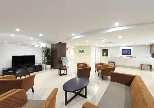 a lobby with a waiting room with chairs and a flat screen tv at Koriyama - Hotel / Vacation STAY 45300 in Koriyama