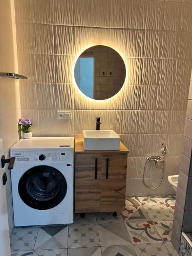 a bathroom with a washing machine and a sink at Green Plaza-SeaView in Aktau