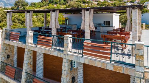 an outdoor balcony of a building with tables and chairs at Arabela 2 Apartments in Utjeha