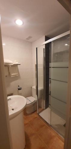 a bathroom with a toilet and a sink and a shower at Hotel Gomar in San Martín de Moncayo