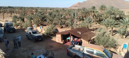 a group of people standing around a tent in a desert at Maggaman Guest House in Tafraoute Sidi Ali