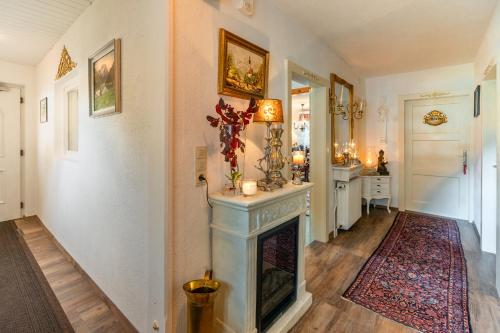 a living room with a fireplace and a hallway at Villa Daringer in Mayrhofen