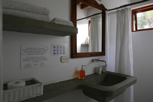 a bathroom with a sink and a mirror at Casa Verde Hotel in Santa Marta