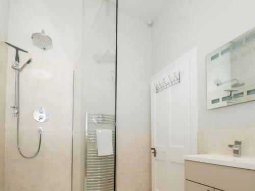 a bathroom with a shower and a sink at St Saviours Reach in Dartmouth