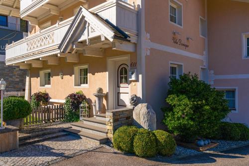 a building with a porch and stairs in front of it at Villa Daringer in Mayrhofen