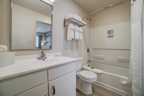 a bathroom with a sink and a toilet and a mirror at WaterWalk San Antonio at The Rim in San Antonio