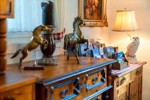 a wooden dresser with statues of horses on it at Villa Daringer in Mayrhofen