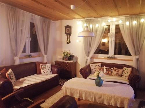 a living room with a couch and a couch and a table at Holiday Home Slavica in Kupres