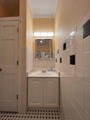 a bathroom with a sink and a mirror at Elaine's Cape May Boutique Hotel in Cape May