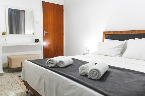 1 dormitorio con 1 cama grande y toallas. en Blue Levant Guest House, en Famagusta