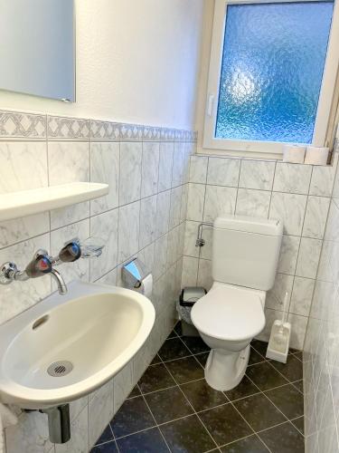 a bathroom with a white toilet and a sink at Schöne grosse Attika-Wohnung im Zentrum von Vaduz inkl. Parkplatz in Vaduz