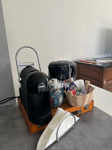 a coffee maker sitting on a wooden tray next to a table at Takàlcastel 2 in Cisterna dʼAsti
