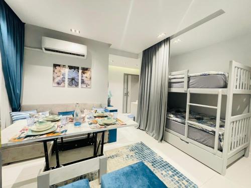 a room with a dining table and bunk beds at Luxury Studio House 589-2 in 6th Of October