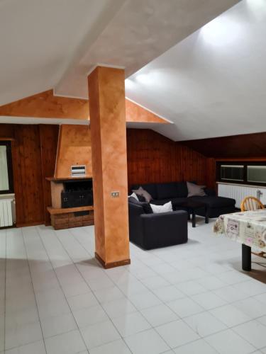 a living room with a couch and a table at Affittacamere airport orio Bergamo in Orio al Serio