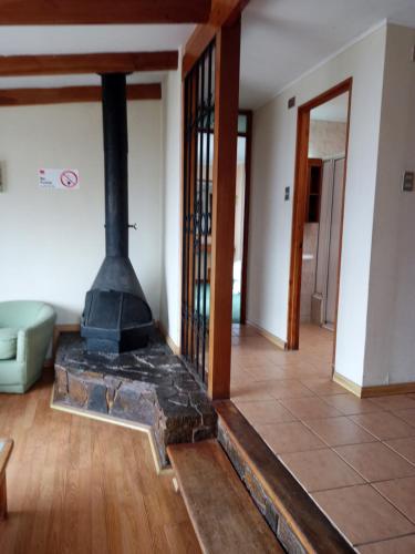 a living room with a stove in the middle at Mistral La Herradura in Coquimbo