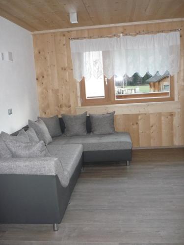 a living room with a couch and a window at Apartments Resi in Rasùn di Sotto