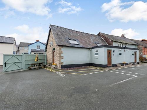 a house with a parking lot with a garage at The Boars Head Pub in Bishops Castle