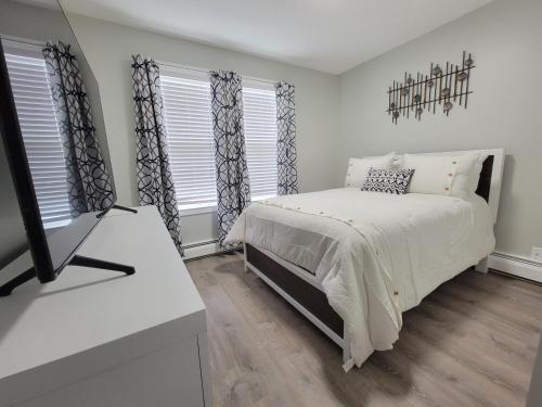 a bedroom with a bed and a mirror at One room for rent shared bathroom and kitchen in Hartford