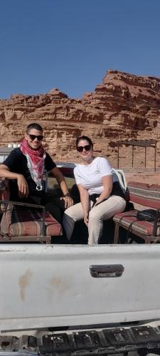 two people sitting in the back of a truck at Rum Aranda camp & Jeep Tour in Wadi Rum