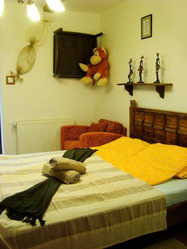 a bedroom with a bed with a teddy bear on the wall at Édes Otthon Vendégház in Nagybörzsöny