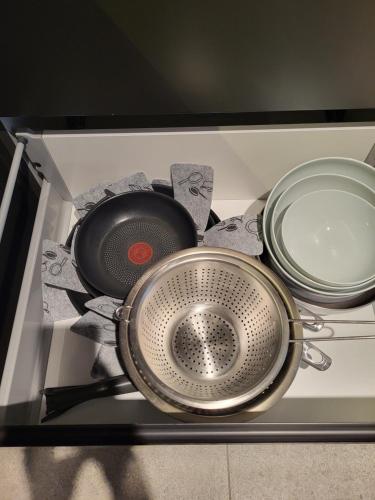 a group of pots and pans sitting on top of a stove at Luxury Copper Apartment in Łódź