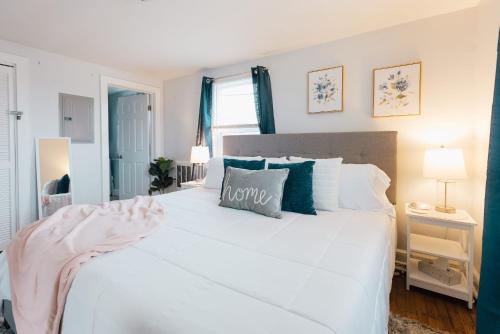 a bedroom with a large white bed with blue pillows at Villa Chic near Downtown Bristol King Bed in Bristol