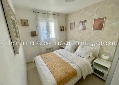 a white bedroom with a bed and a window at Charming cosy apart with garden free parking in Claye-Souilly