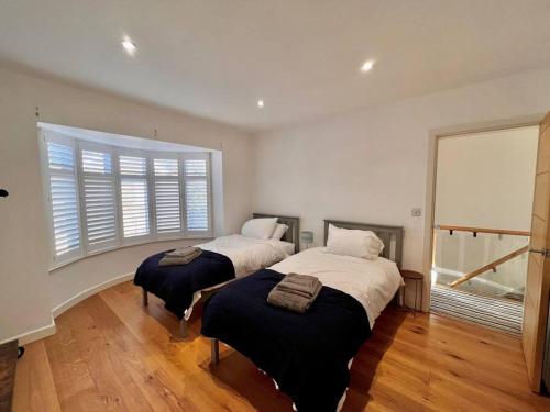 um quarto com 2 camas e uma grande janela em Stylish 3 bed house with Castle views em Lincolnshire