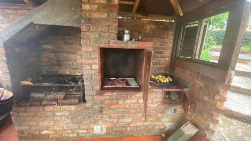 an outdoor brick oven with food in it at Chalet Amadeus Guatavita in Guatavita