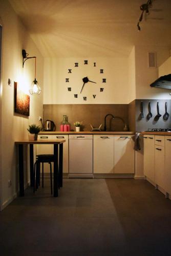uma cozinha com um grande relógio na parede em Warszawa Centrum Pokoje em Varósvia