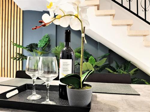 a table with a bottle of wine and two glasses at Royal Lovely Apartment! in Paphos City