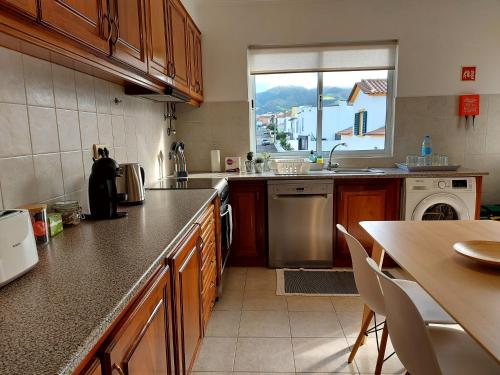 a kitchen with a counter and a sink and a window at Beach & Surf in Ribeira Grande