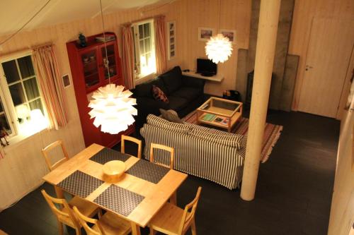 a living room with a table and a couch at Gålå Fjellhytte - cabin with sauna and whirlpool tub in Sør-Fron