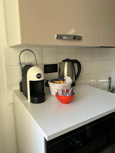 a kitchen counter with a coffee maker and a toaster at Takápradalù in Cisterna dʼAsti
