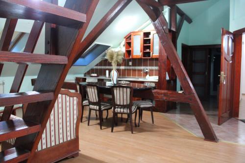 a dining room with a wooden table and chairs at Siesta in Kikinda