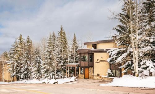 a building with snow covered trees in front of it at Laurelwood Condominiums 309 in Snowmass Village