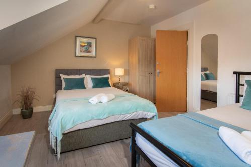 a bedroom with two beds in a attic at 147 The Residence in Belfast